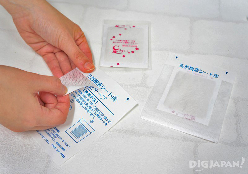 Peel the paper off of the adhesive cloth