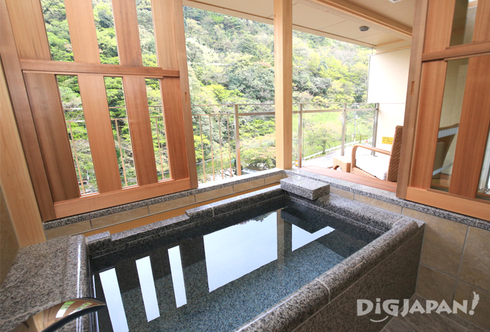A room with a private open-air rotenburo baths at Hotel Okada