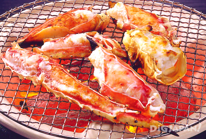 Crab grilling over charcoal 